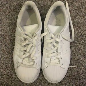 All white Adidas Superstars
